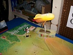 Its a turn later, and the wind has shifted... blowing the Balloon along the edge of the battlefield as Cowman Clone #2 pursues!  Note the stack of...