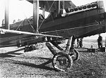 Close-up of the wing bomb racks on a DeHavilland DH-4 aircraft, France, 1918. Note the field installed mudguards over the tires designed to keep the...