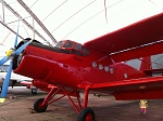 Interesting red plane. But if you look to the bottom right hand corner, you can see a small pixie wondering about under the wing.