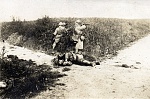 Geschossen 
 
Nothing on reverse. 
 
Vicinity of Courcelles, June 1918. 
 
The body of a German soldier lies on a pathway as a French soldier takes...