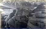 Detailed view of a German machinegun nest 
 
Nothing on reverse. 
 
A German machinegun crew peer across no-man's-land above the barrel of their...