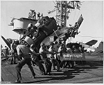 Sailors work to reclaim typhoon damaged planes.