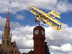Caproni over Mudgee 
 
It is over the well known Mudgee Clock Tower (commemorating the 50th anniversary of WW2) with the Catholic church in the...