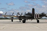 Lancaster in front followed by B-25 taxing for takeoff.