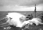 Oil tanker attempting to fuel another ship as the typhoon moves in.