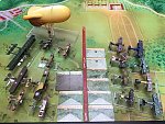 An American summer
https://www.wingsofwar.org/forums/showthread.php?36860-WW1-campaign-AMERICAN-SUMMER

A friendly confrontation based on a Wings of War West section mat and a 4-run scenario pitting Americans ([i][b]Monse[/b][/i]) against Germans ([i][b]Tiopepe[/b][/i]) in the summer of 1918 (German aircraft with nationality markings and right crosses post-April 1918).
This campaign is linked to the desire to use American aircraft in a relatively coherent way historically (the Nieuport 28 began to be removed from the front in August 1918, while the Fokker E.V arrived in the German squadrons).

- [u]Round 1[/u] "Balloon drop": an Allied [b]balloon[/b] is tasked with spotting five German entrenched infantry and artillery positions (including 2 machine guns and an anti-aircraft gun). Suggested post-game modification: replace a Trench card with a second AA gun). Two American fighters [b]Spad XIII[/b] (Rickenbaker) and [b]Nieuport 28[/b] (Hartney) are tasked with protecting it from attack by a [b]Fokker Dr.I[/b] (Rahn) and a [b]Pfalz D.III[/b] (Holtzem). 

One of the German fighters is equipped with incendiary bullets, but the Americans don't know which one: it will be identified when the balloon or aircraft suffers special damage (excluding flame) or a value of 5 points (WOG rules p35). 

The anti-aircraft gun can take aim without having been discovered by the balloon's observers, but will be revealed when the gun is fired (rules for using the gun, pages 32-33-34 of the WOG Rules and Accessories booklet).
At the end of each game turn (three programmed maneuver cards), the balloon loses one climb counter (or one altitude level if no climb counter) and a land position card is revealed.
The balloon is defended by two anti-aircraft machine guns, which can only target aircraft at altitudes 1 and 2. 
At the start of the game, the aircraft start at altitude 4, and the balloon also at altitude 4 and two climb counters.

- [u]Round 2[/u] "Two-seaters on the horizon": two American two-seaters [b]Airco DH4[/b] (50th Squadron AEF) and [b]Brguet 14[/b] (Browning/Duke), each with a bomb load, are tasked with neutralizing the anti-aircraft gun first, then possibly 4 trench positions, two of which have anti-aircraft machine guns. The German sector is protected by a [b]Fokker E.V[/b] (Lowenhardt) recently arrived on the front and an [b]Albatros D.Va[/b] (Jentsch).

- [u]Round 3[/u] "Heavy in action": a French [b]Caproni Ca.3[/b] bomber (CEP 115), escorted by a US [b]SPAD XIII[/b] (Luke), lends a hand to their allies by destroying the enemy positions resisting the first offensive with three bomb loads. Two highly maneuverable German fighters [b]Fokker D.VII[/b] (Starck) and [b]Siemens Schuckert D.III[/b] (Lange) will try to prevent this.

- u]4th round[/u] "Soldiers, we attack!" American ground troops will have to cross the width of the map to seize enemy positions, with air support from a [b]RAF SE5a[/b] (Boudwin) and a [b]Spad VII[/b] (Soubiran). Two German two-seater assault aircraft [b]Halberstadt CL.II[/b] (Schwartze/Schumm) and [b]Hannover CL.IIIa[/b] (Luftstreikrafte) will harass the US infantry (represented by two cards that will advance one card's width at the end of each game turn).

[u]For practical purposes[/u], each player controls two different aircraft, with a pack of Wings of War maneuvers for one miniature and Wings of Glory maneuvers for the other, to facilitate card retrieval and sorting after each game phase.
Maneuver cards are sorted by movement type (straight line, turn, swooping maneuvers, etc.) on the card holders.
Each side has its own A and B damage decks: WoW A and WoG B for the Germans, and WoG A and WoW B for the Americans, to make it easier to sort the A and B cards at the end of the game, and to distribute the damage evenly between the two players.
The C damage pack for anti-aircraft guns and aircraft collisions is common to both sides.